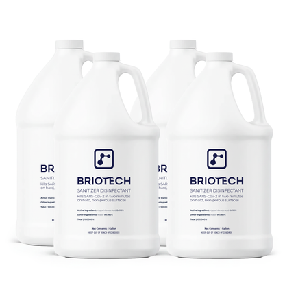 Four one-gallon white bottles of Sanitizer Disinfectant with blue labels kill bacteria and viruses, including SARS-CoV-2 in two minutes on hard, non-porous surfaces.