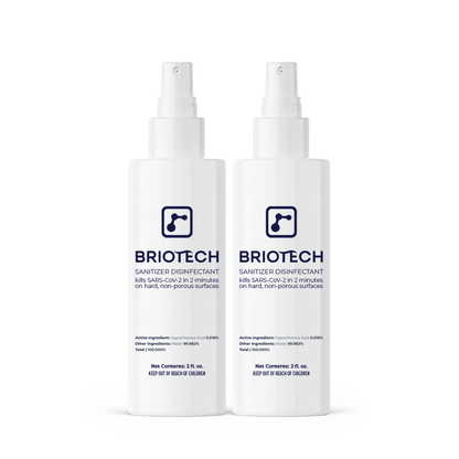 Two white bottles of Sanitizer Disinfectant with blue label are side by side. This spray kills bacteria and viruses, eliminating SARS-CoV-2 in 2 minutes on hard, non-porous surfaces.