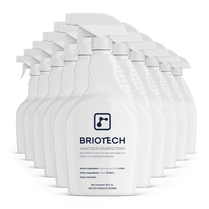 A row of twelve white Sanitizer Disinfectant spray bottles, proven to kill SARS-CoV-2 in two minutes on hard, non-porous surfaces and effectively eliminate bacteria and viruses.