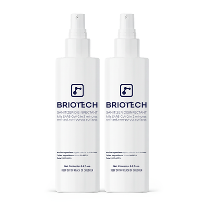 Two white bottles of Sanitizer Disinfectant with spray tops, labeled as a disinfecting spray that kills bacteria and viruses on non-porous surfaces in 2 minutes, featuring and safety info on the labels.