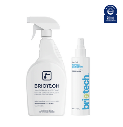 The Daily Essentials Duo featuring a large white trigger spray bottle of HOCl sanitizer disinfectant next to a smaller white pump bottle of topical skin spray, with a National Eczema Association seal in the top right corner.