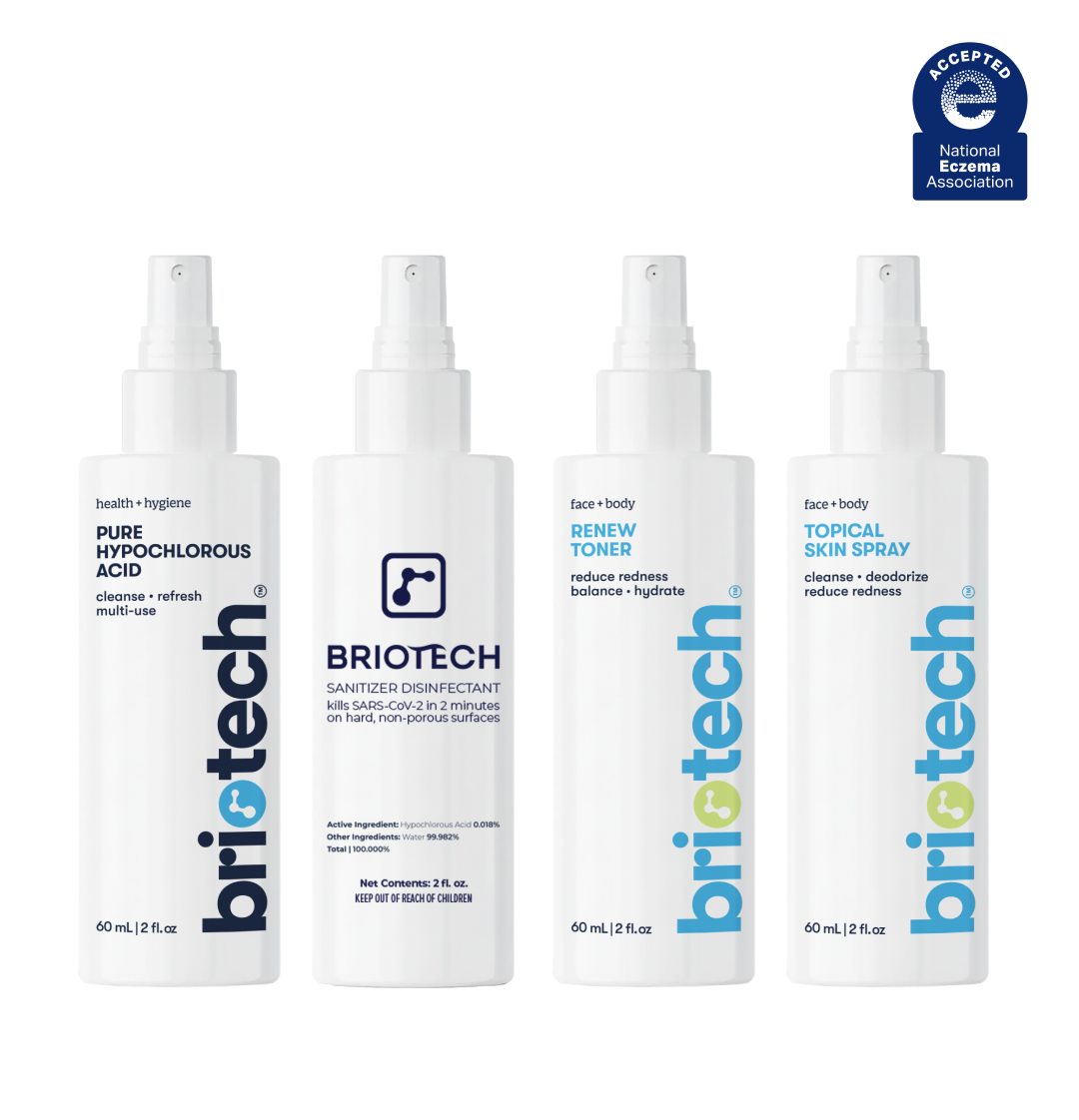 Travel Essentials Kit containing four spray bottles labeled as hypochlorous acid skin spray, sanitizer disinfectant, facial toner, and topical spray, with a National Eczema Association seal in the top right.