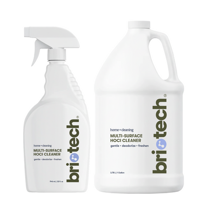 A white 32-ounce trigger spray bottle and a white 1-gallon refill jug, both from the Multi-Surface Cleaner + Refill Bundle and labeled as Multi-Surface HOCl Cleaner.