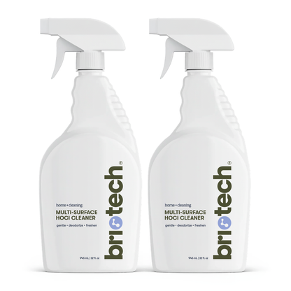 Two white spray bottles labeled Multi-Surface HOCl Cleaner with white nozzles are positioned side by side against a plain white background, highlighting an effective cleaning and deodorizing solution for your home or office.