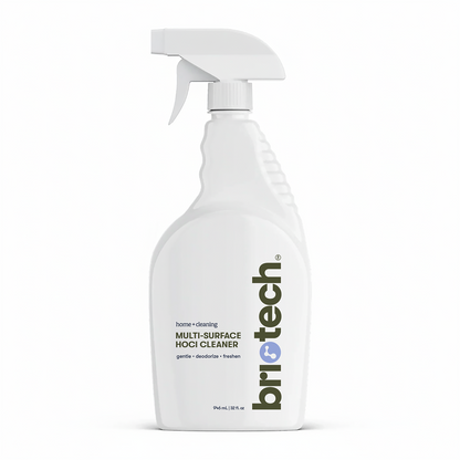 A white spray bottle labeled "Multi-Surface HOCl Cleaner" features text highlighting its gentle cleaning, deodorizing, and freshening abilities. This advanced solution is designed as an effective multi-surface cleaner and comes with a white trigger spray top.