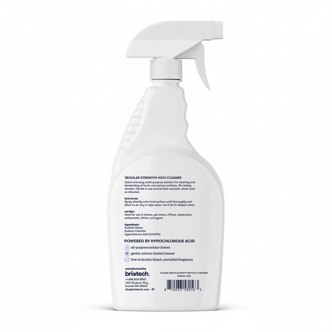 White spray bottle of Multi-Surface HOCl Cleaner, shown from the back with clear label text, usage instructions, ingredients, and company contact details visible. This regular strength cleaner by Britech is deodorizing and safe for kids and pets.