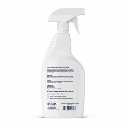 White spray bottle of Multi-Surface HOCl Cleaner, shown from the back with clear label text, usage instructions, ingredients, and company contact details visible. This regular strength cleaner by Britech is deodorizing and safe for kids and pets.