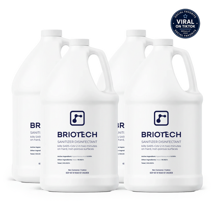 Four white gallon jugs of Sanitizer Disinfectant are displayed with blue labels. Intended for use against bacteria and viruses on non-porous surfaces, the bottles are arranged together on a white background. A blue circular “Viral on TikTok” sticker is positioned in the top right corner.