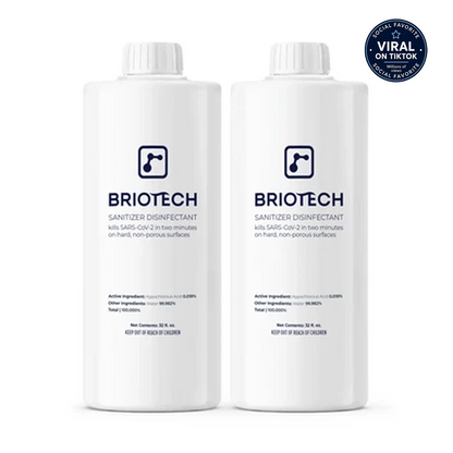Two white bottles of Sanitizer Disinfectant stand side by side, displaying blue text and logo. Ideal as a disinfecting spray for non-porous surfaces, these bottles help protect against bacteria and viruses. A “Viral on TikTok” badge appears in the top right corner.