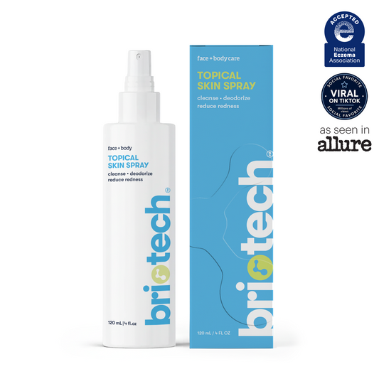 A white spray bottle labeled Topical Skin Spray stands beside its blue and yellow box, showcasing badges for National Eczema Association acceptance, TikTok virality, and an “as seen in Allure” feature. This soothing formula is expertly crafted to calm irritation and reduce blemishes, making it a must-have in your skincare routine.