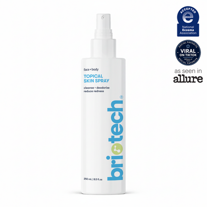 White bottle labeled Topical Skin Spray with blue and green text. Certifications include the National Eczema Association seal and a “Viral on TikTok” badge. The text features “as seen in Allure.” This soothing spray is formulated to calm irritation and reduce blemishes, making it a gentle option for sensitive skin.